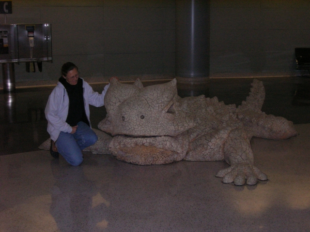 Amy admiring a unique lizard statue.