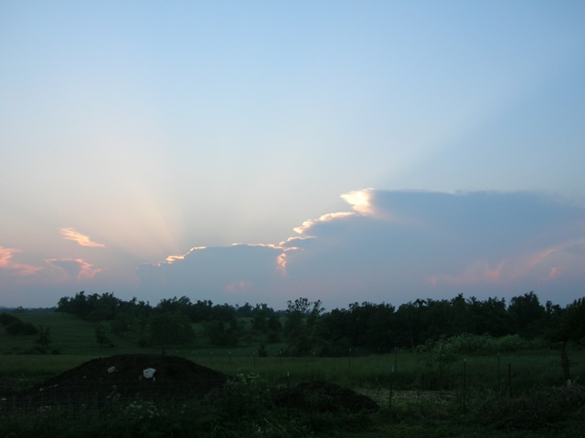 Rays emanate past a gathering storm.