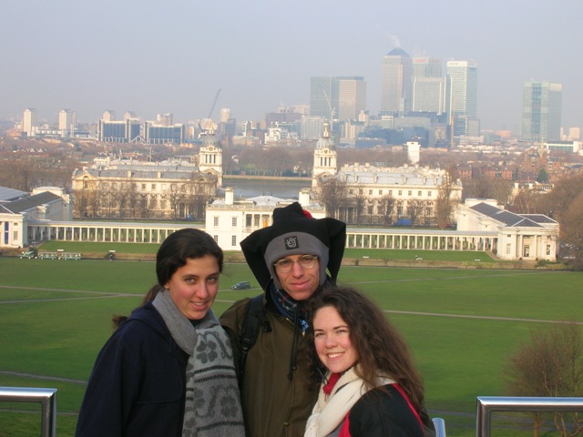 Here we are at the Royal Observatory at Greenwich in London, backdropped by our most favorite part of London, the Docklands. The Prime Meridian and the atomic clock that functions as THE standard of time stand nearby.