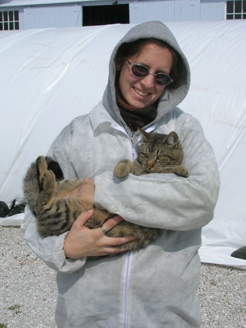 Lindsay holding Merry after busily uncovering cold frames, hence the white(ish) suit.