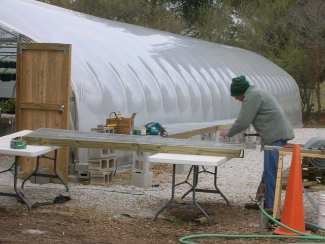 Oscar building new benches for the new greenhouses.