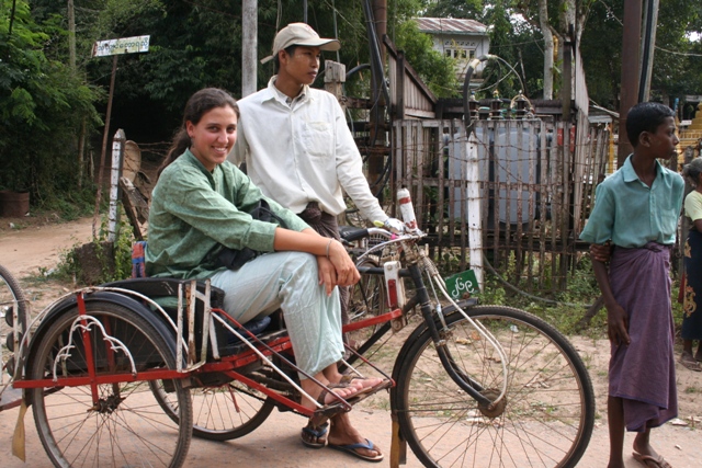 Emily ready to ride into a nearby village aboard a trishaw. The guys are wearing what are called longis.